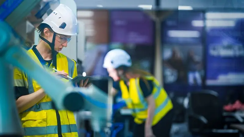 QHSE engineer entering inspection data on tablet in industrial environment, Slaeb QHSE module